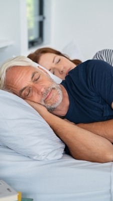 man and woman sleeping in bed
